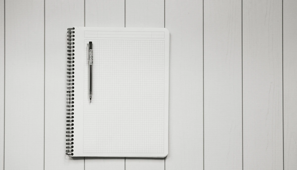 A pen resting on a squared notebook